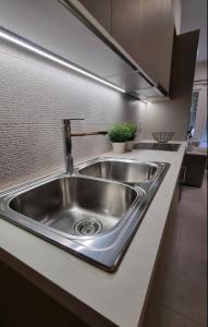 a stainless steel sink in a kitchen at LV Apartments Ioannina in Anatolí