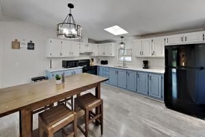 a kitchen with a wooden table and a black refrigerator at Island Club #21 in Put-in-Bay +20 photos