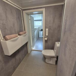 a bathroom with a toilet and a sink at Just Sleep Arendal in Arendal