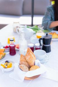 a table with bread and other food on it at Casa Pitoresca - Refugio Esposende in Gemeses