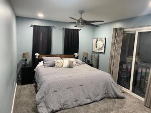 a bedroom with a bed and a ceiling fan at Large Recreational Retreat in Hudson +32 photos
