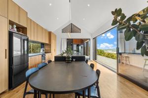 a kitchen with a table and a large window at Seafront, Sauna, Architecture The Surf Nest Full House 