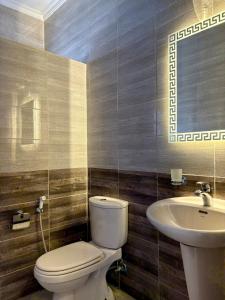 a bathroom with a toilet and a sink at Exquisite & inviting 2 Bedroom 2 bath Balcony Fast internet in Amman +22 photos
