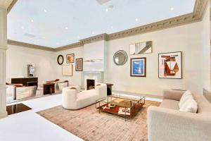 a living room with two couches and a fireplace at Well-Equipped Apartment Close to Metro Station in Addison Heights +14 photos