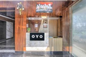 a lobby with an ovo sign on the wall at SPOT ON Hotel Blue Diamond Inn in Bihta