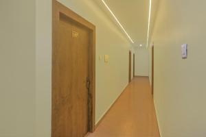 an empty hallway with a wooden door and a hallway at SPOT ON Hotel Blue Diamond Inn in Bihta