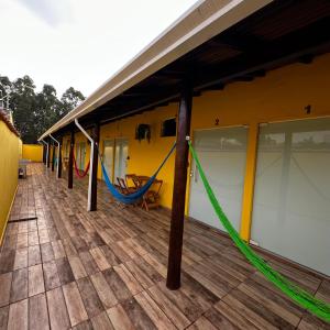 a building with a porch with a hammock on it at Apartamento completo AC & Cozinha - centro Brotas - SP in Brotas