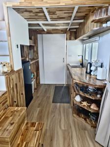 a kitchen with wood floors and a counter top at Samui Tiny House villa Glamping, Seaview sleeps 8 in Koh Samui