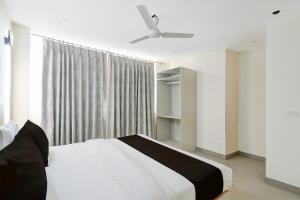 a bedroom with a white bed and a window at Hotel O Kalka in Indraprast