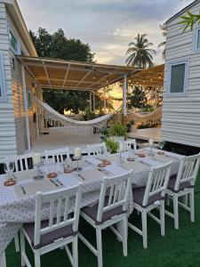 a white table and chairs on a patio at Samui Tiny House villa Glamping, Seaview sleeps 8 in Koh Samui