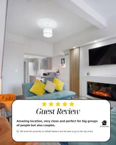 a living room with a couch and a fireplace at Burnand House - Air Host & Stay - Sleeps 9 in Liverpool