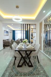 a dining table and chairs in a living room at Bubbles Cozy Homes Two bedroom apartment in Mombasa