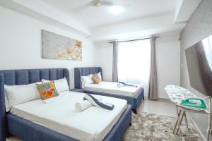 a room with two beds and a couch and a chair at Bubbles Cozy Homes Two bedroom apartment in Mombasa +30 photos