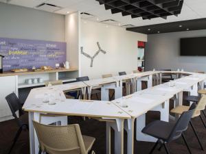 a row of tables and chairs in a room at Ibis Mazatlan Marina in Mazatlán