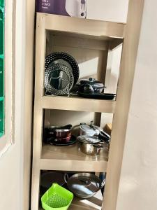 a cabinet filled with pots and pans in a kitchen at Holiday cabin in Sibey in Hāpoli +10 photos