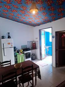 a kitchen with a table and a ceiling covered in flowers at Paraty Mirim - Refugio Montanha in Paraty +20 photos