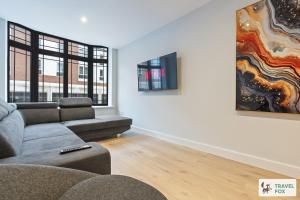 a living room with a couch and a tv at Blair's Central Stay in Nottingham