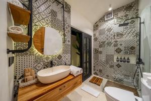 a bathroom with a sink and a mirror at Balance, Beauty and WiFi - Find It All at Sarang Apartments 2 in Ubud +6 photos
