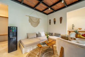 a living room with a couch and a table at Balance, Beauty and WiFi - Find It All at Sarang Apartments 2 in Ubud