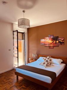 a bedroom with a bed and a chandelier at B&B Lary in Pescara