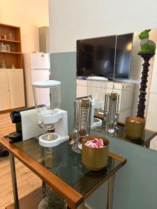a glass table with various items on top of it at B&B MaKri in Boltiere