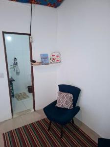 a blue chair sitting in a room with a mirror at Paraty Mirim - Refugio Montanha in Paraty