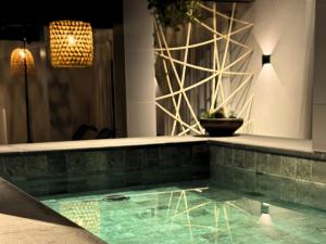 a swimming pool in a room with a chandelier at Kastel Petrópolis in Petrópolis