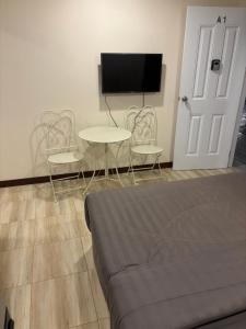 a living room with a couch and two chairs and a table at TheBloomMahasarakham in Maha Sarakham