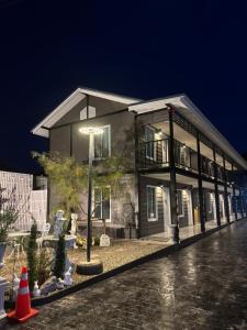 a house with a street light in front of it at TheBloomMahasarakham in Maha Sarakham