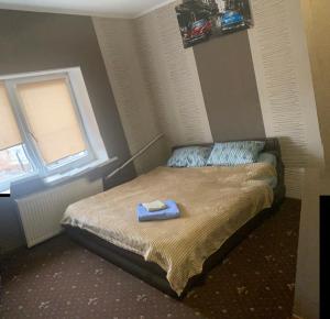 a bedroom with a bed with a towel on it at Шервуд in Zhytomyr
