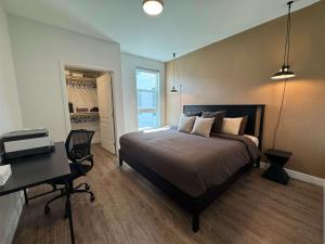 a bedroom with a large bed and a desk and a desk at Luxury Stay Near Disneyland With Pool Gym & Free Parking in Tustin +63 photos