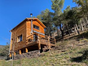 a wooden house on a hill with trees at chalet bois montagne Urbanya Occitanie in Urbanya