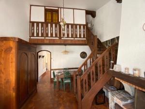 a room with a staircase and a table with chairs at Maison proche de la mer in Sainte-Marie-la-Mer