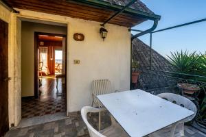 a white table and chairs on a balcony at 322 - Crueza de Ma, Relax e Terrazza con vista sul mare di Moneglia in Moneglia