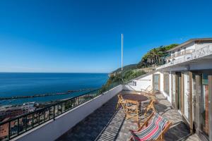 a balcony with a table and chairs and the ocean at 322 - Crueza de Ma, Relax e Terrazza con vista sul mare di Moneglia in Moneglia