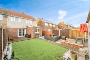 a garden with a lawn in the backyard of a house at Warm & Spacious 3-Bed Retreat in Doncaster in Bentley