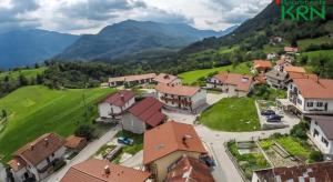 an aerial view of a village in the mountains at Apartments Krn in Drežniške Ravne