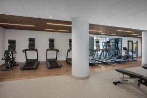 a gym with a row of treadms and elliptical machines at Courtyard by Marriott San Diego Downtown Little Italy in San Diego
