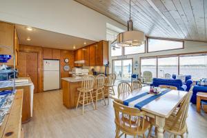 a kitchen and dining room with a table and chairs at Beachfront Whidbey Island Home and Apartment! in Langley
