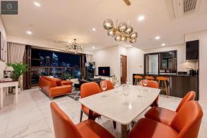 a living room with a table and chairs at The Metropole Deluxe Apartment View City in Ho Chi Minh City +110 photos