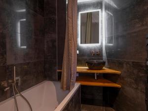 a bathroom with a bath tub and a sink at Chalet de Luxe à Avoriaz - 12 Pers, Sauna, Cheminée, Services Premium Inclus - FR-1-314-97 in Morzine +13 photos