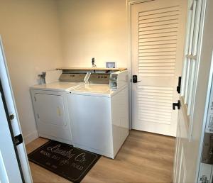 a washer and dryer in a room next to a door at Hygge Hus Hotel in Andrews +51 photos