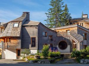 a large house with a gambrel roof at Chalet d'exception à Avoriaz, 16 pers, sauna, home cinéma, salle de fitness, services inclus - FR-1-314-95 in Morzine