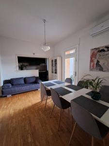 a living room with a blue couch and a table at Apartman Soda in Ogulin
