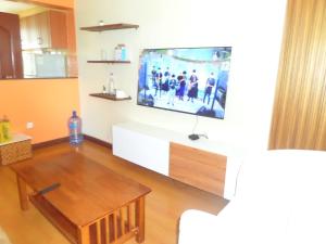 a living room with a flat screen tv on the wall at Sunshine in Nairobi