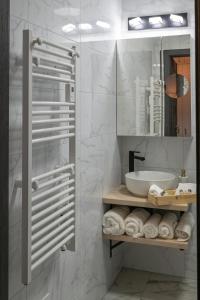 a bathroom with a sink and a mirror at Bliss & Relax Central Apartment Debrecen, Free Parking in Debrecen