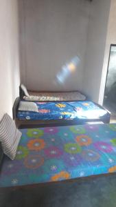 two beds sitting next to each other in a room at HOME bed in Angunawala
