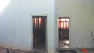 a room with two doors in a room with a wall at HOME bed in Angunawala