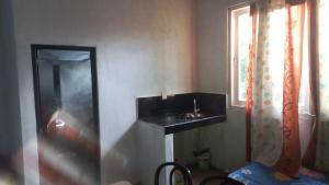 a bathroom with a black sink and a window at HOME bed in Angunawala