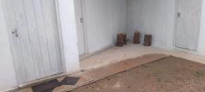 a room with white walls and two doors at HOME bed in Angunawala